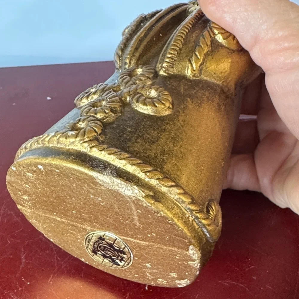 vintage chalkware candle holder featuring a metallic gold-finished figure